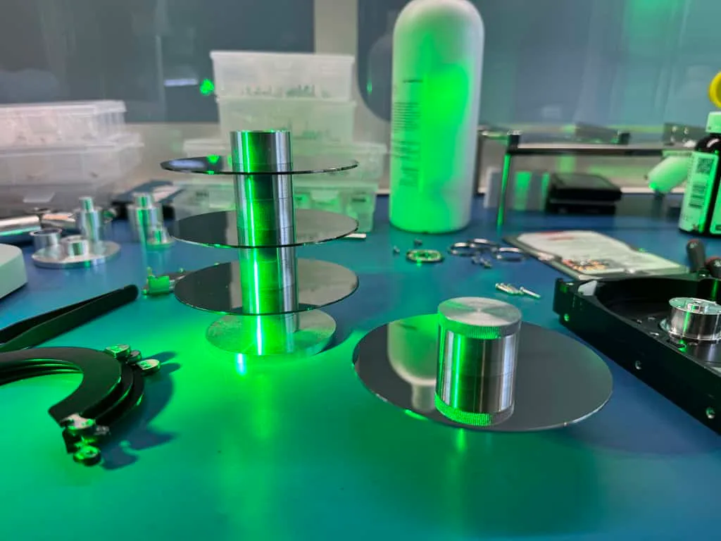 Hard drive platters on a spindle in the MDrepairs data recovery cleanroom