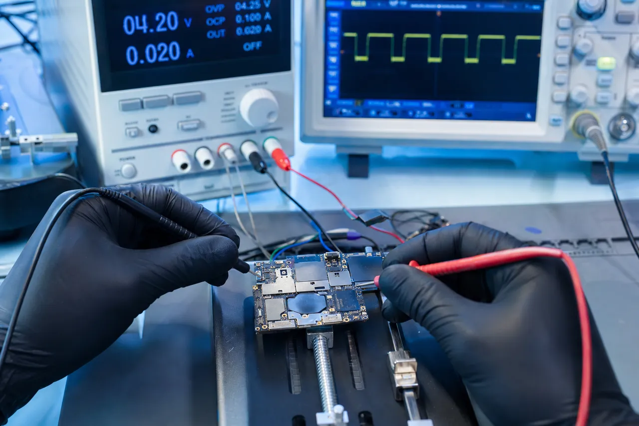 Samsung Galaxy motherboard wired to a bench power supply and oscilloscope to trace power rails